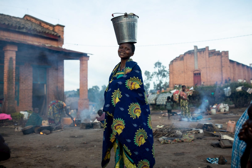 A woman from the Congo stands and looks at the camera