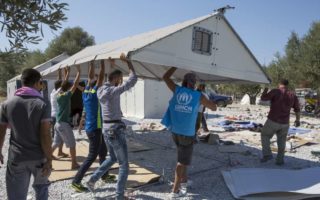 People assembling an IKEA shelter