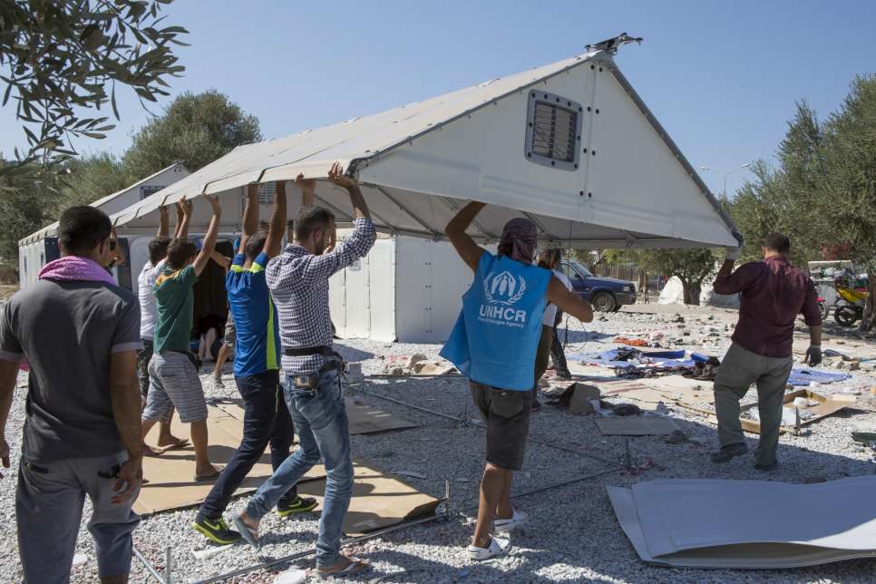 People assembling an IKEA shelter