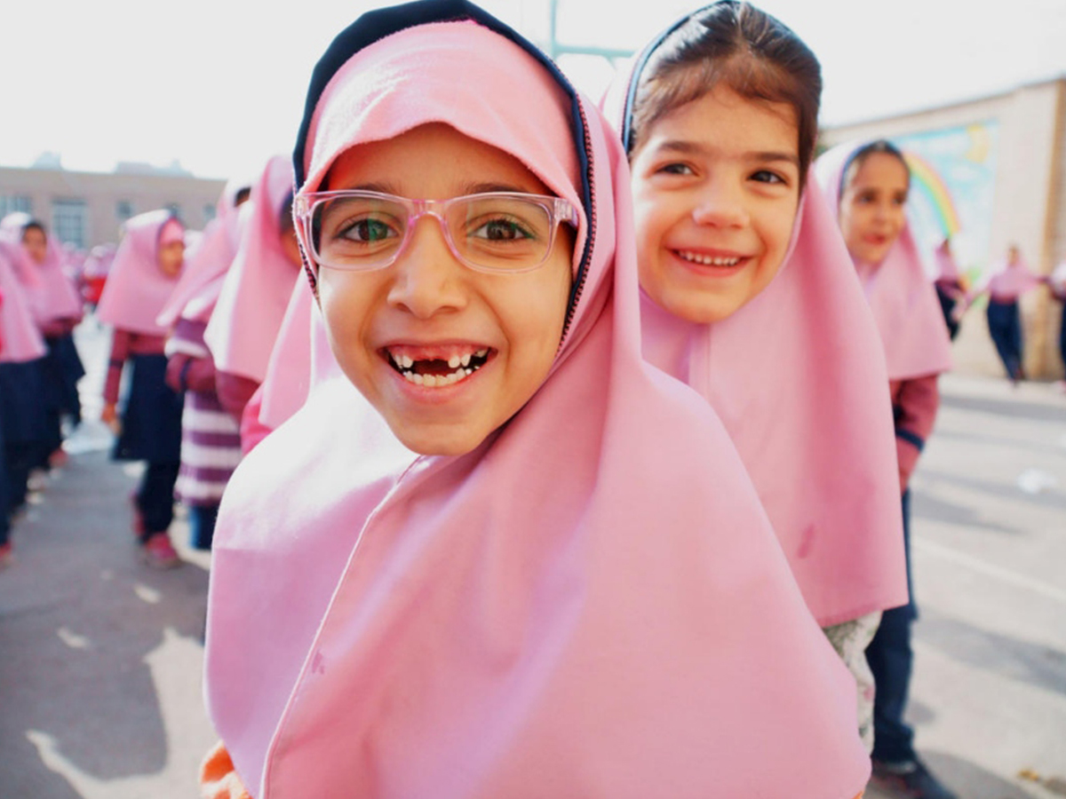 Two young girls from Iran smile