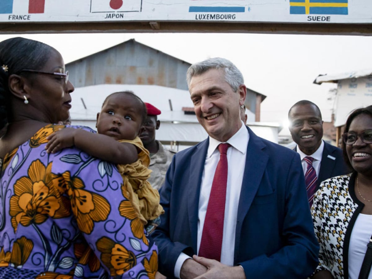 UN High Commissioner for Refugees Filippo Grandi greets a refugee on her return to Bangui, the Central African Republic