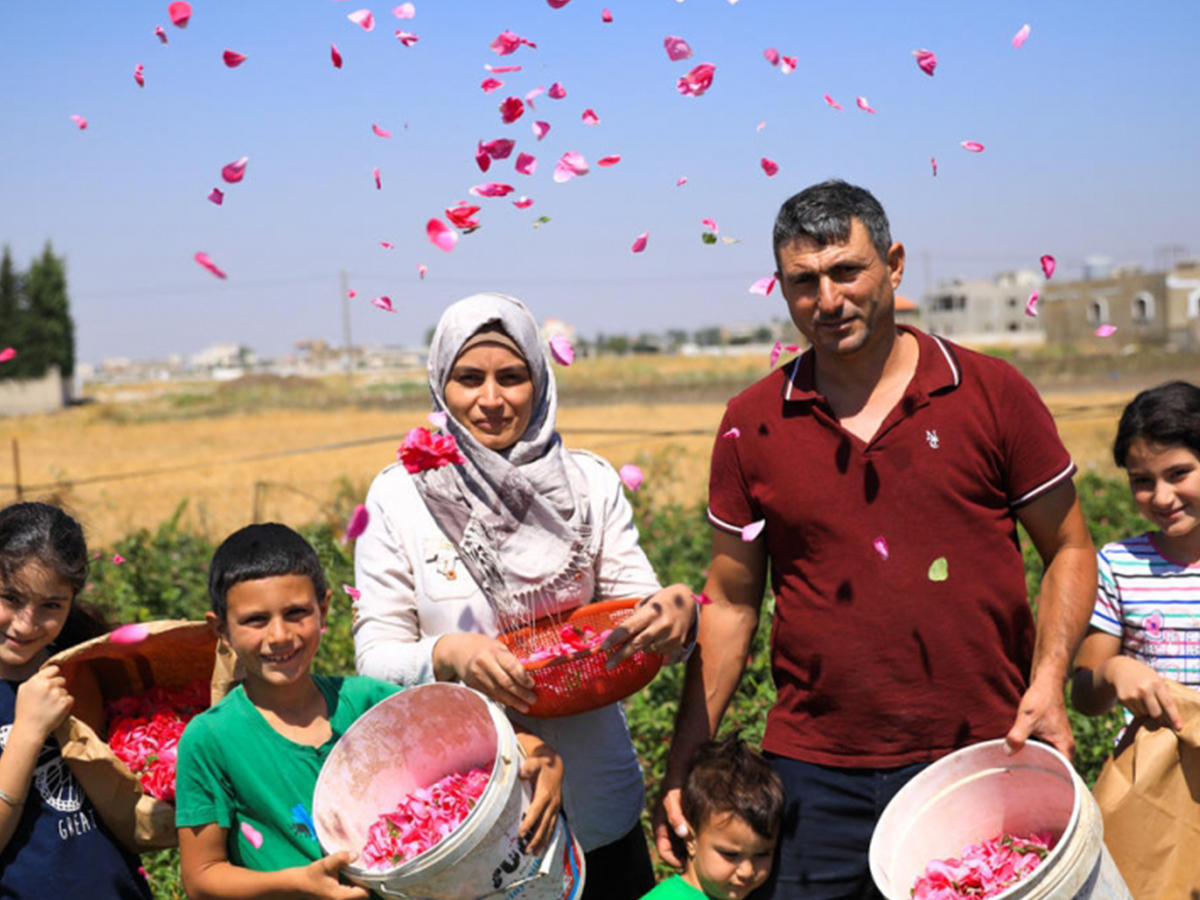 A family stands with their rose harvest