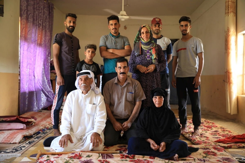 An Iraqi farmer family stands in their home