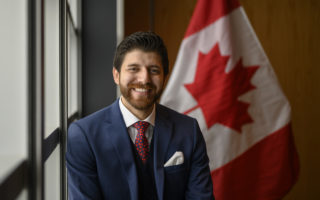 Tareq Hadhad, a Syrian refugee and founder of Peace by Chocolate, poses prior to his Canadian citizenship ceremony at Pier 21 in Halifax, Nova Scotia