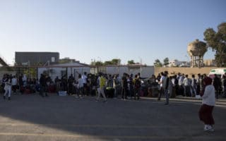 refugees standing in courtyard