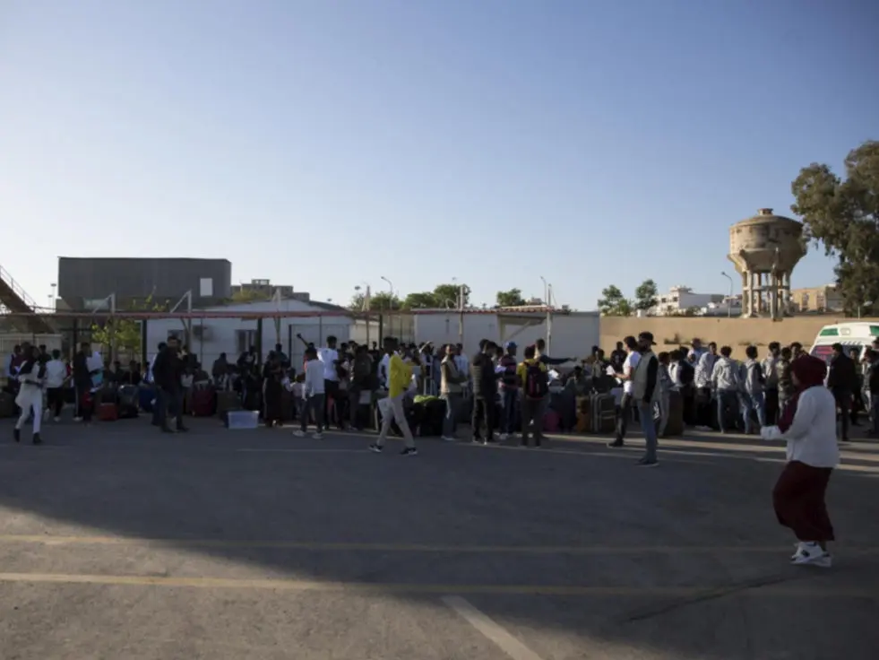 refugees standing in courtyard