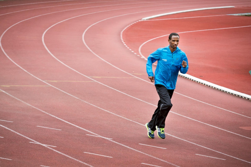 A runner (athlete) trains on a track