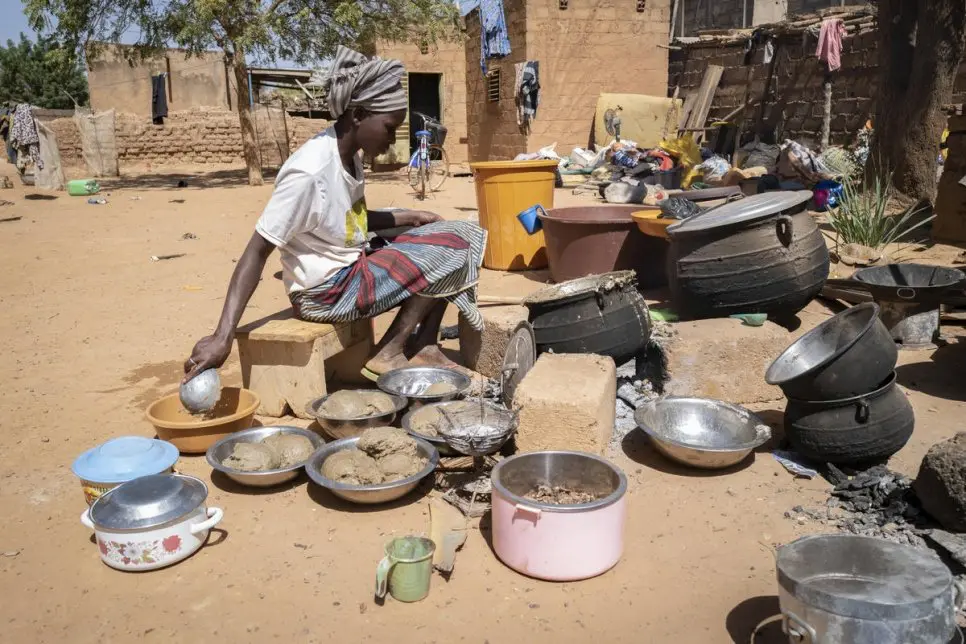 A woman cooks food outside in Burkina Faso