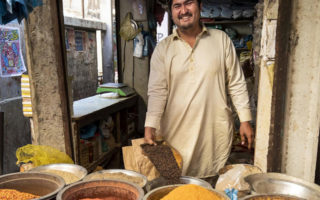 Afghan man in Pakistan tending a spice stand