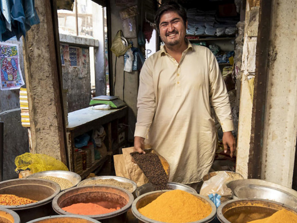 Afghan man in Pakistan tending a spice stand