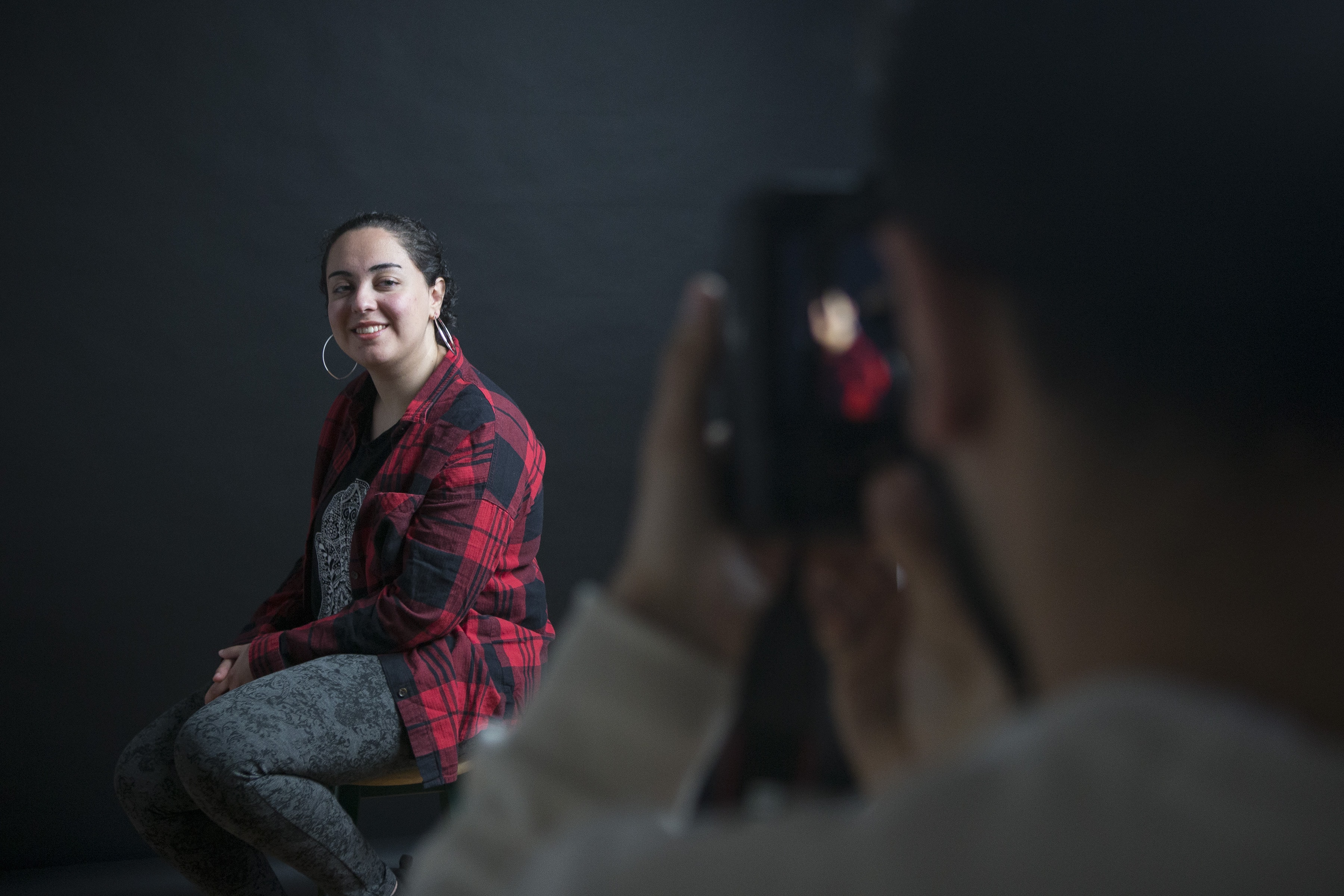 A photo of a photographer taking a portrait photo of a woman