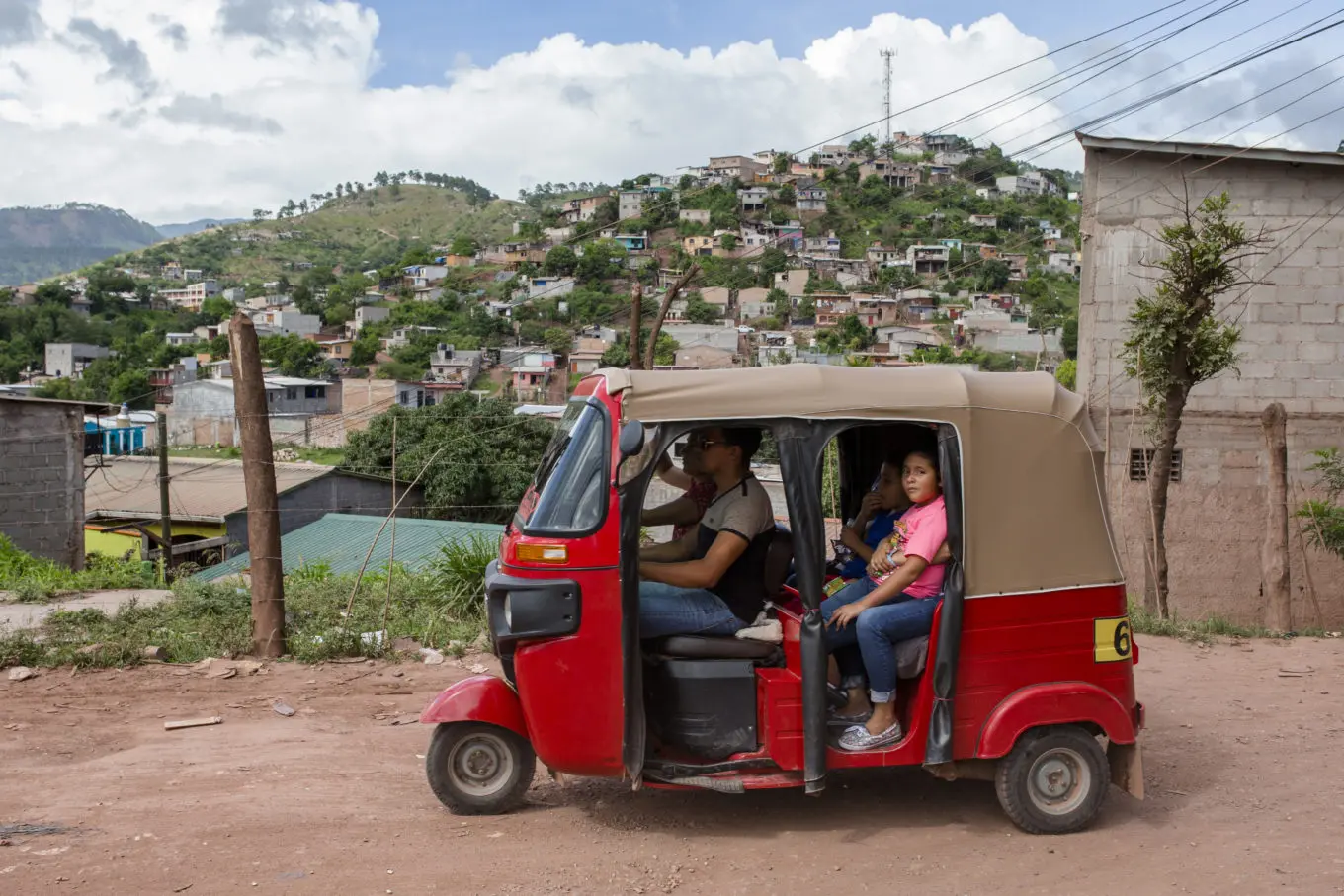 Locals sit in a rickshaw in the La Era neighbourhood of the Honduran capital Tegucigalpa. ; An estimated 174,000 Hondurans have been displaced by territorial violence from gangs, known as “maras”, in the decade between 2005 and 2015, according to a report from the Honduran government. The country had the highest homicide rate in the world in 2014 and families continue to abandon their homes in search of safer environments in the United States, Mexico and neighbouring Central American countries like Belize. In communities in cities like San Pedro Sula in the north, residents tell stories of relatives whose houses have been burned down, young boys being recruited into gangs and young girls too afraid to attend school because of the unwanted attentions of “mareros” (gang members). The UN Refugee Agency chief in Honduras, Andrés Celis, says mechanisms for people seeking protection from the government must be improved so that the state can respond more effectively to displaced people’s needs for shelter and relocation.