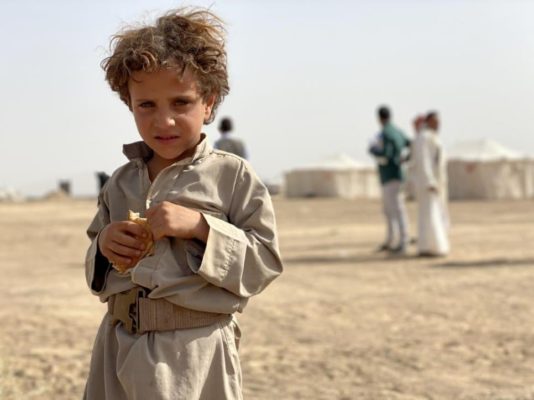 A child standing in a desert