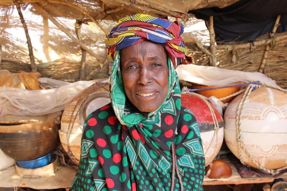 A portrait of a smiling woman in colourful clothing