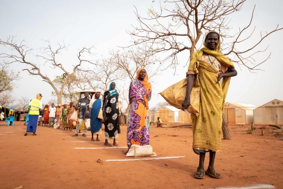 Women standing in a line 6 feet apart from one another