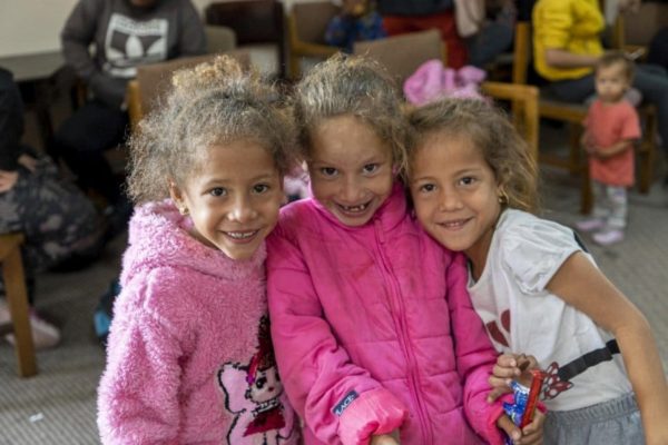 Three young girls pose for a photograph