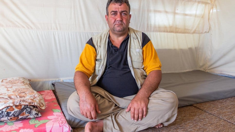 Out-of-work Syrian refugee Farhad sits in his tent at Bardarash camp in Duhok, Kurdistan Region of Iraq