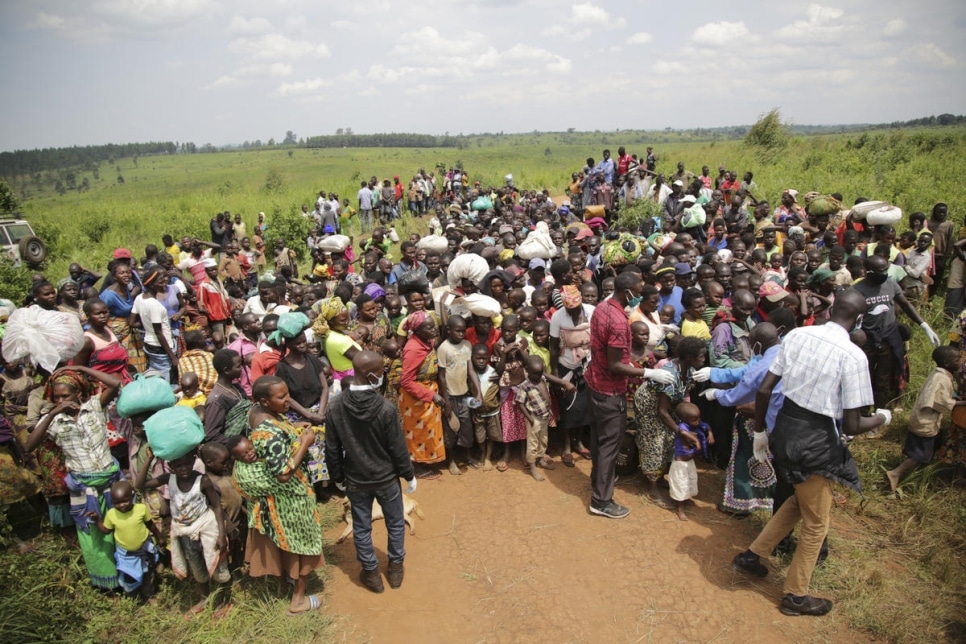 Asylum-seekers from the Democratic Republic of the Congo wait for health screening near the border in Zombo, Uganda