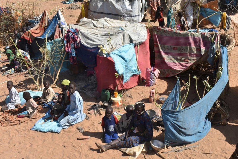 Sudanese refugees who fled inter-communal violence in West Darfur sit beside makeshift shelters in Mamata village, Chad, 19 January 2020