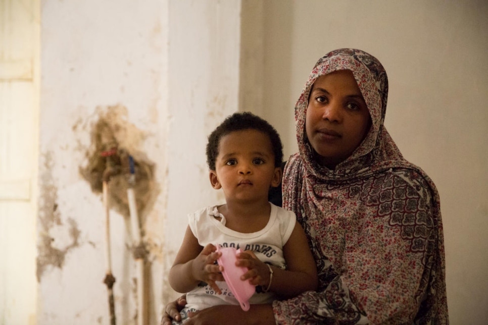 An Eritrean refugee mother and son shelter at the home of a Sudanese refugee in Tripoli, Libya, July 2019