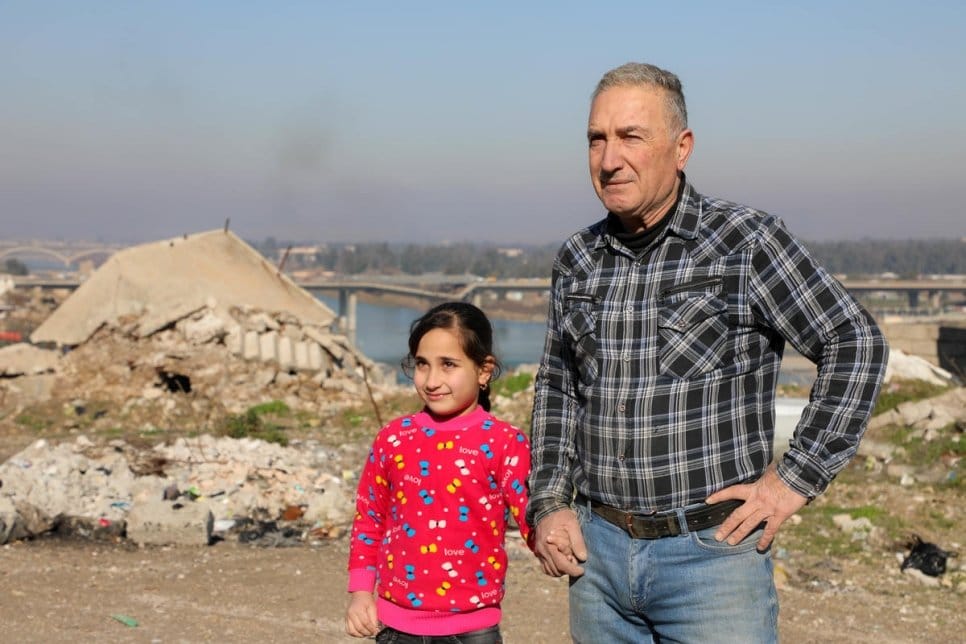 Saad and his daughter Ashwaq walk through their damaged neighbourhood in Mosul’s Old City