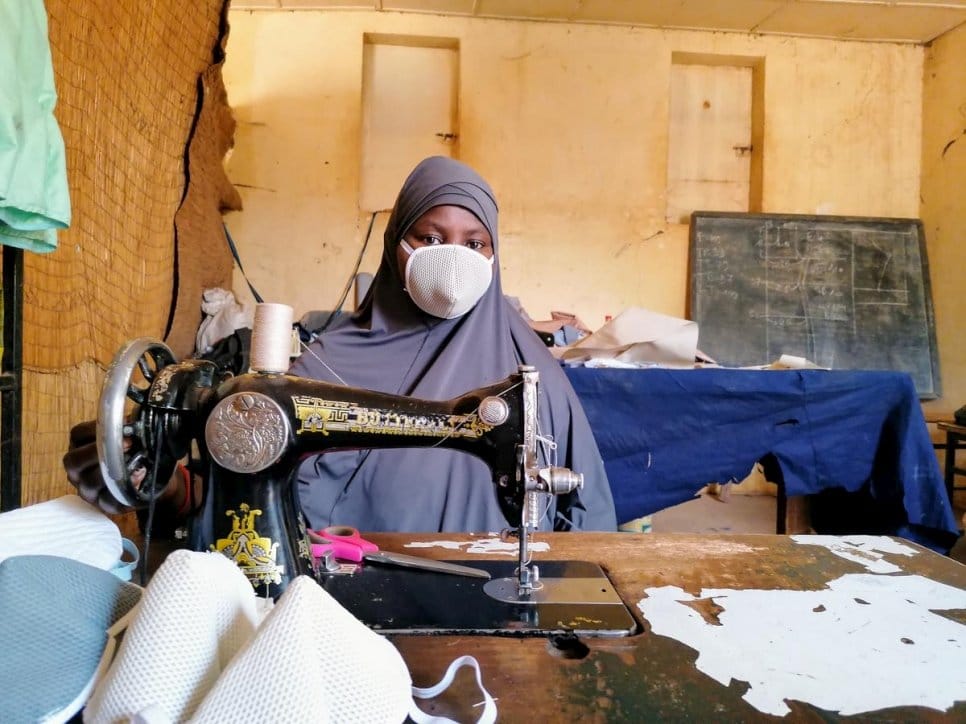 Zeinabou wears one of the 40 face masks she makes each day in Niamey