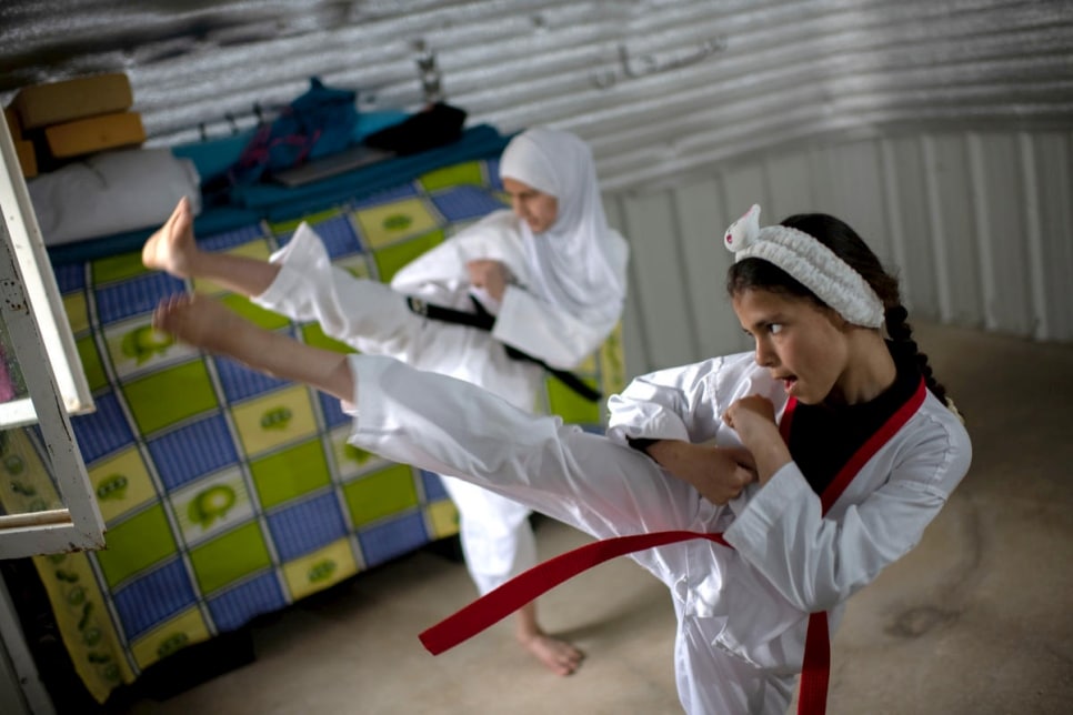 Syrian sisters Zeinab and Rayan practice Taekwondo during lockdown at their home in Azraq refugee camp, Jordan