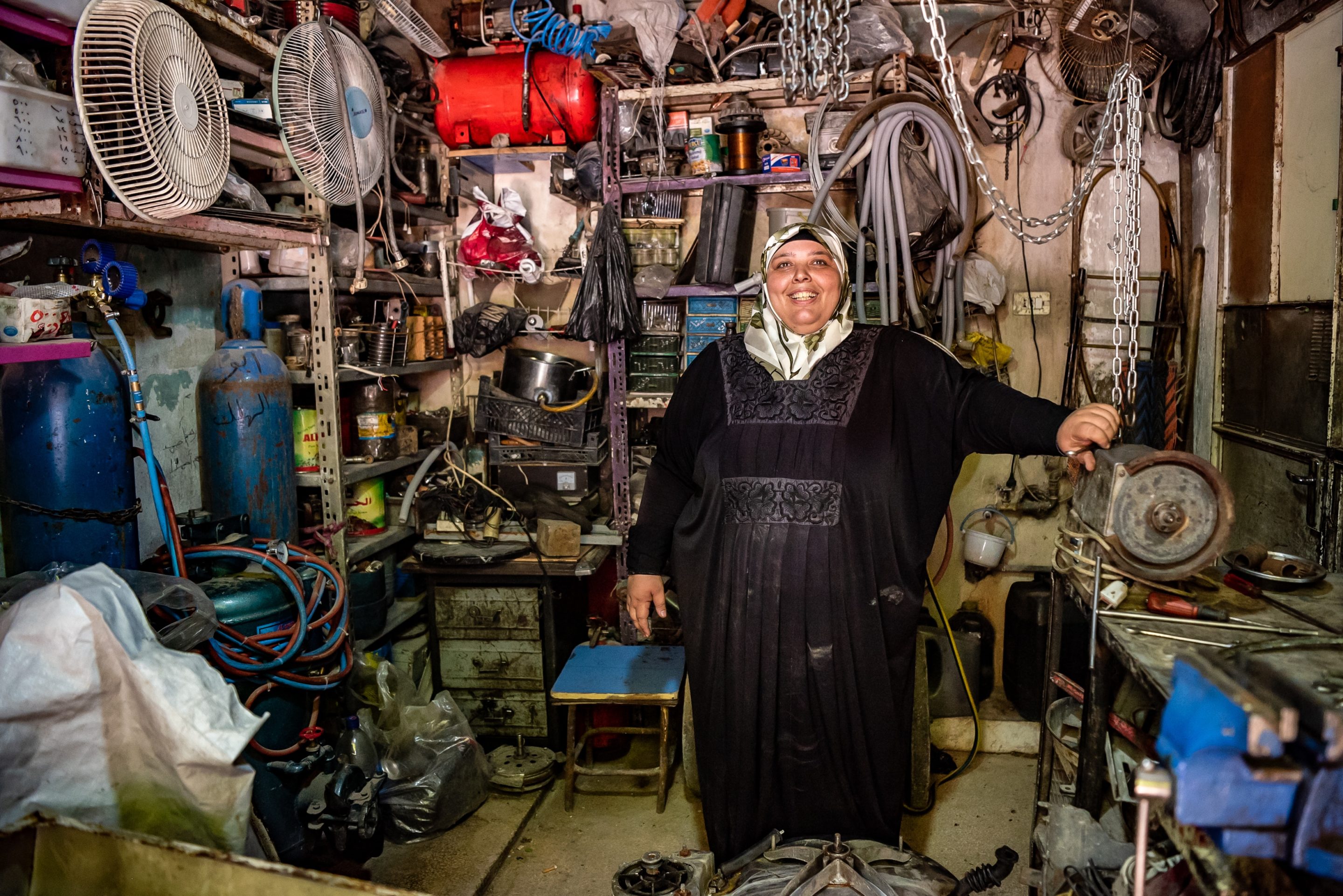 A woman stands in front of her wares 