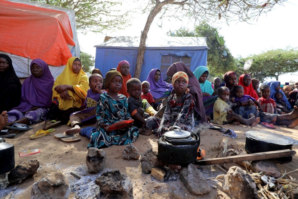 Somalis driven from the Lower Shabelle region by fear of airstrikes sit under a tree at a site for internally displaced people near Mogadishu, March 2020