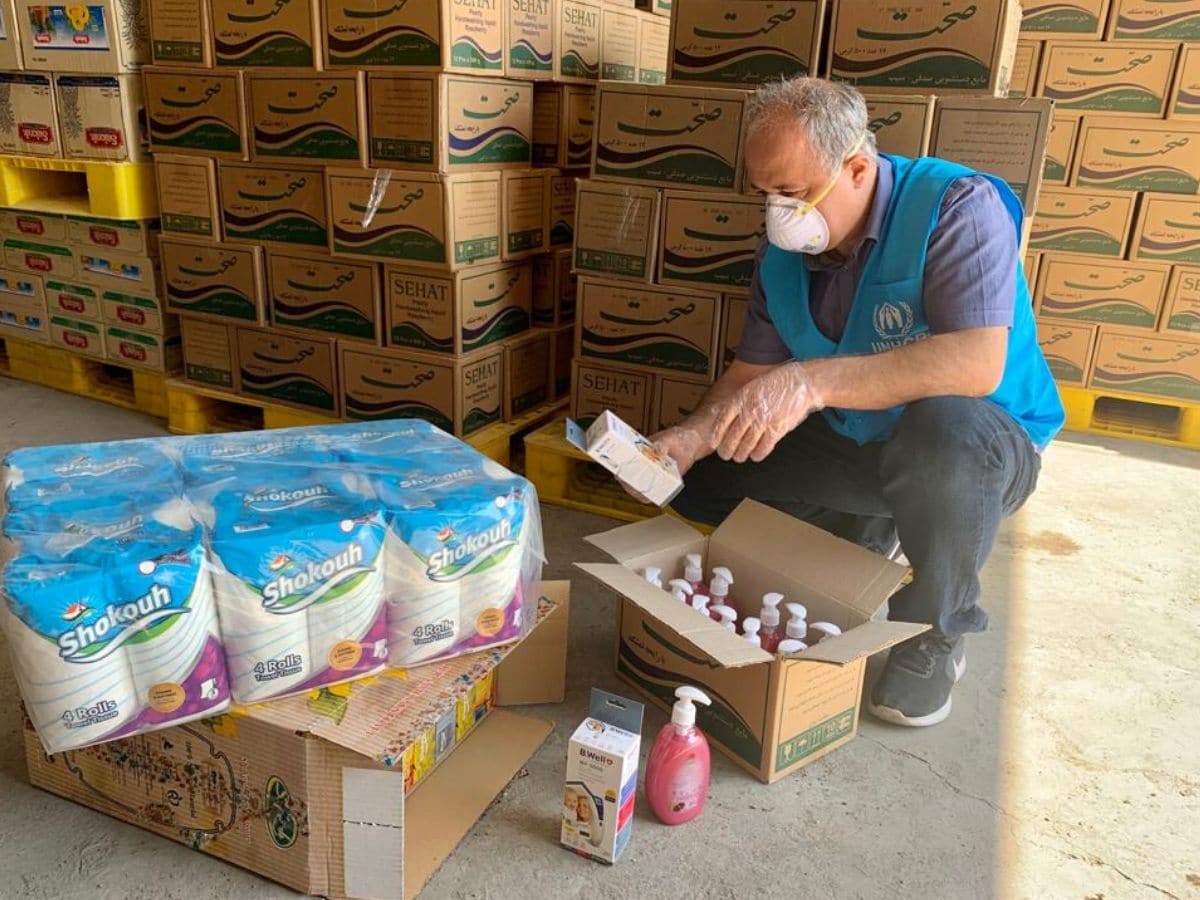 UNHCR staff verifies aid-items before distribution to refugee settlements in Iran, as part of the COVID-19 response