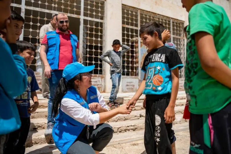 Yumiko Takashima, who heads UNHCR’s office in Aleppo, Syria, meets with children at a school in Kurayhah village in July 2019