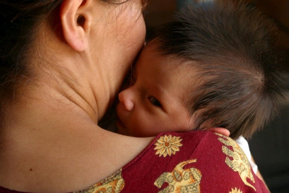 A woman holds her infant in Ashgabat, Turkmenistan, in 2006. Mothers in Turkmenistan can now pass along their nationality to their children