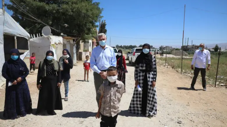 UN High Commissioner for Refugees, Filippo Grandi, poses for a photograph with a group of refugee women in a tented settlement in the Bekaa Valley, Lebanon