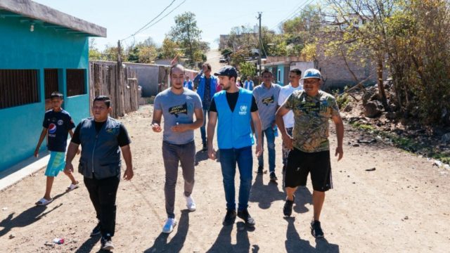 Youth Against Violence head Santiago Ávila shows Mexican actor Alfonso Herrera around a neighbourhood in the Honduran capital where the anti-gang organization is active, in March, 2020