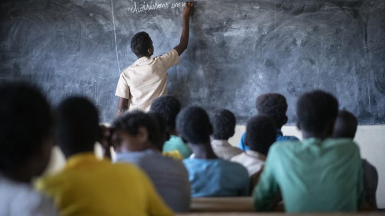 A Malian refugee student plays the role of teacher at a school in Goudoubo camp. Because of rising insecurity teachers no longer show up and students often teach each other