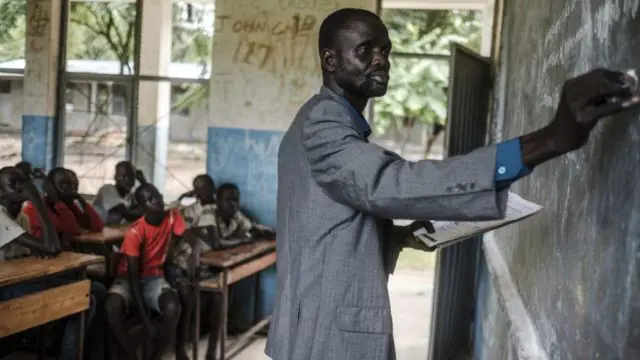 South Sudanese refugee James Tut teaches a class at a primary school in Jewi camp, Ethiopia.