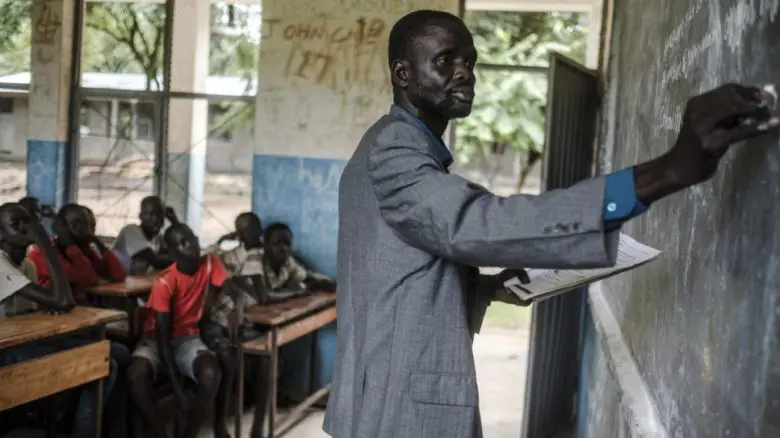 South Sudanese refugee James Tut teaches a class at a primary school in Jewi camp, Ethiopia. 