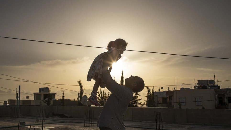 Syrian family Mohammad and his daughter Yasmine on the rooftop of their house in Barja, Lebanon