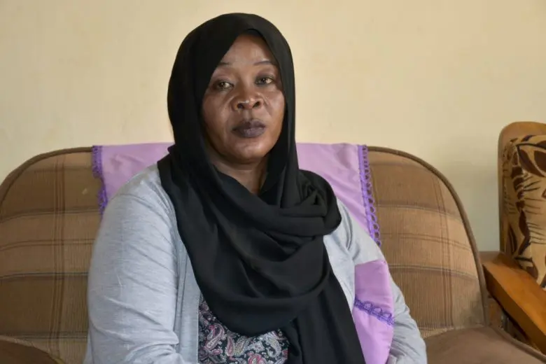 Sudanese woman sitting on a couch