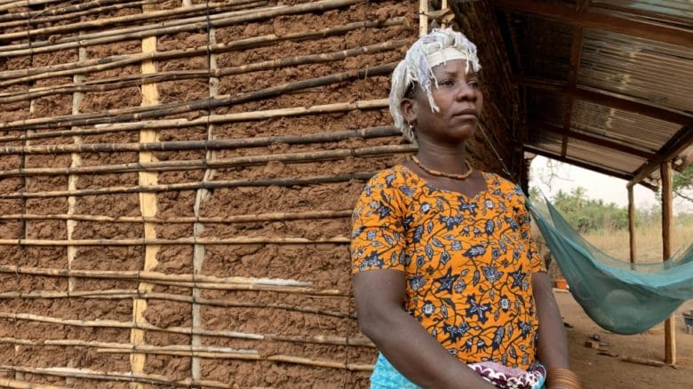 A woman standing outside her home in Mozambique