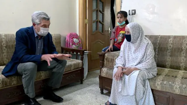 UN High Commissioner for Refugees Filippo Grandi visits a family in Zamalka, Syria, who returned home last year after living in displacement for seven years