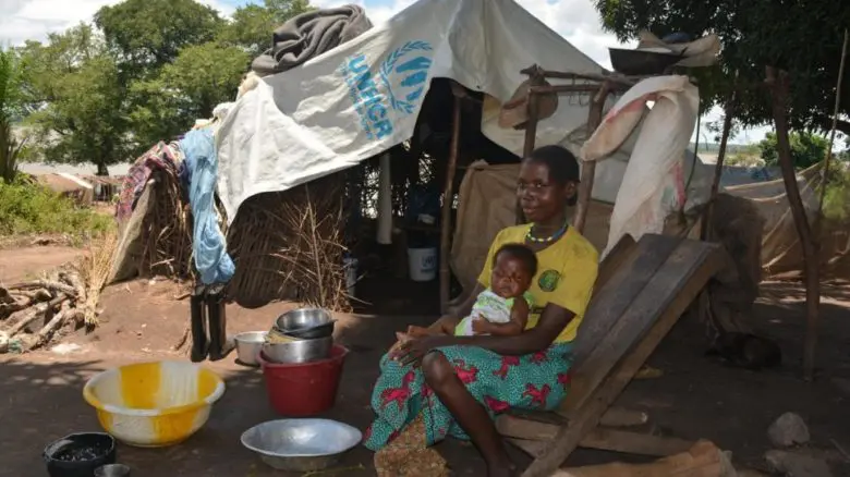 A refugee mother from the Democratic Republic of Congo sits outside a shelter with her baby in Toko Kota in the Central African Republic. 