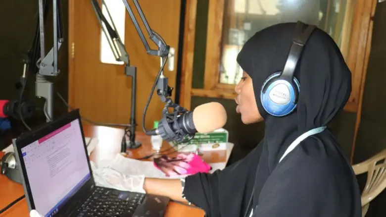 Kenyan teacher Amina Hassan gives an English lesson to grade five students over the radio at Dadaab camp in Kenya. 