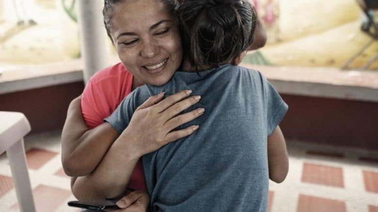 Mayerlin, the Nansen Refugee Award winner, hugs a child