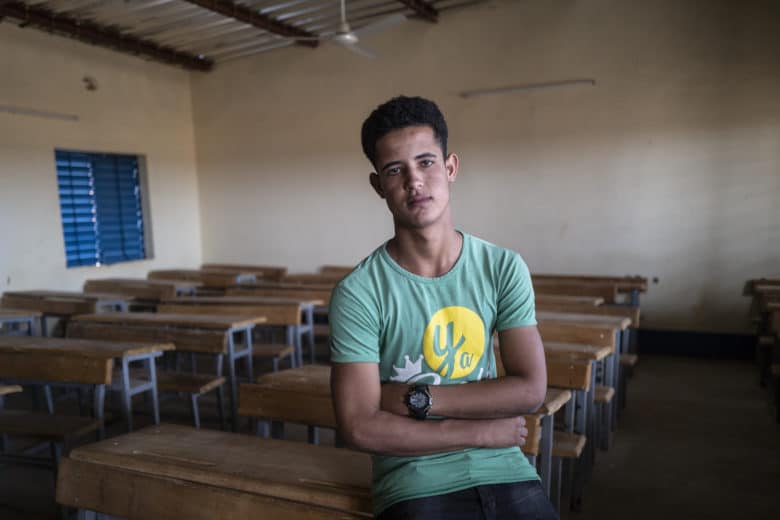 Seventeen-year-old Malian refugee, Mohamed Ould Sidi, sits in the classroom of a school in Goudoubo camp, Burkina Faso