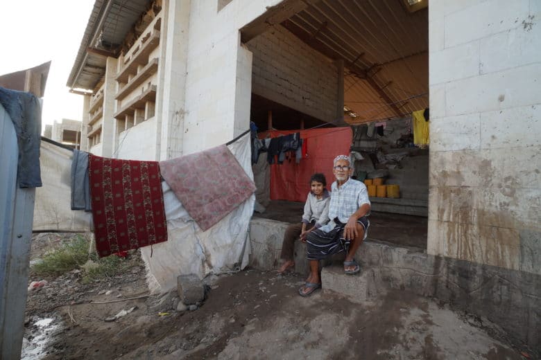 Seventy-five-year-old Ahmed Asslan Saghir was displaced from Al Hudaydah and is now living at Ammar bin Yasser camp in Aden, Yemen with his 12-year-old son