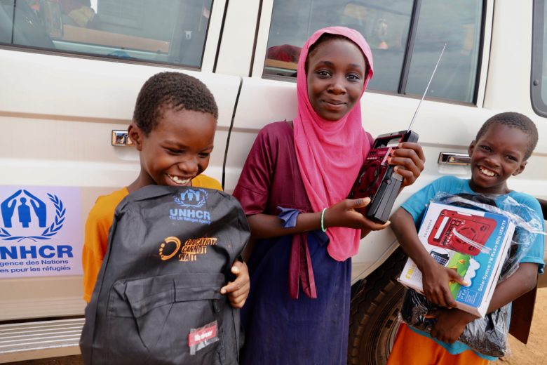 Internally displaced Malian children receive solar-powered radios and school kits from UNHCR at Sarema school, to facilitate distance learning