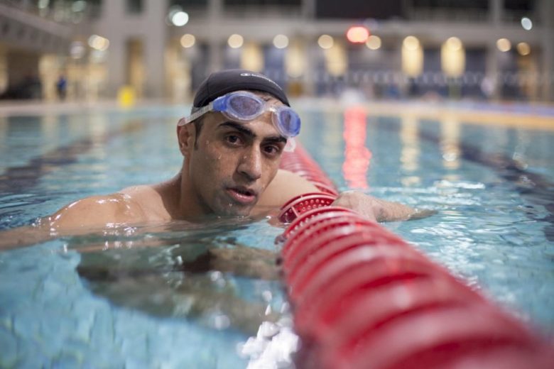 Refugee Paralympian swimmer Ibrahim al-Hussein trains in a swimming pool.