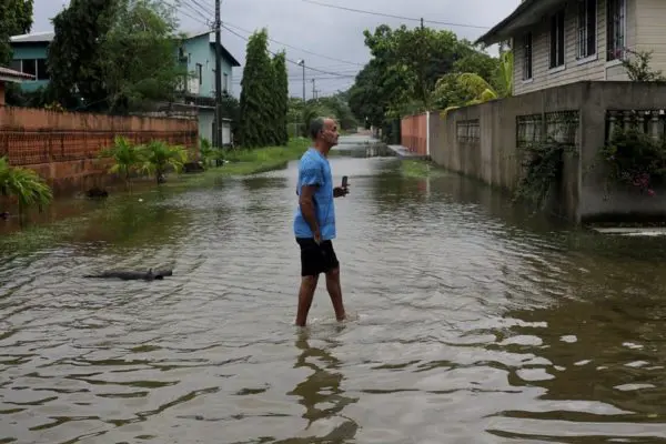 A man walks a flooded street as Hurricane Eta approaches.