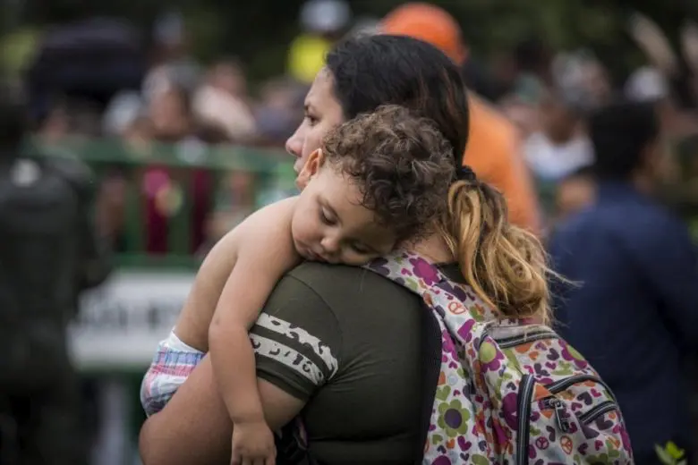 A mother holds her baby.